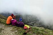 tourists look at misty mountain