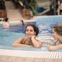 women relaxing in a swimming pool